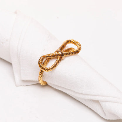 4 ANEIS PARA GUARDANAPOS ENTRE LACOS DOURADO METAL
